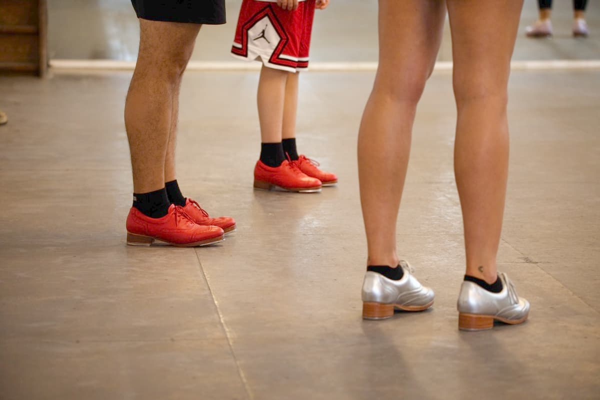 Close up of tap dancer's feet in red shoes