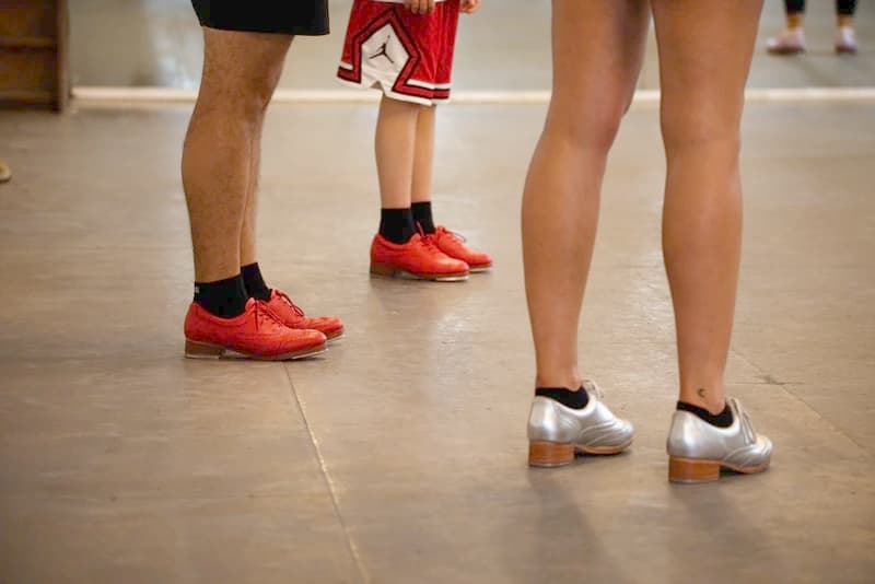 Close up of tap dancer's feet in red shoes